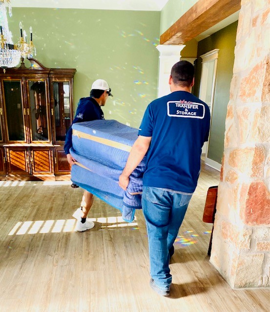 Two men moving a blue furniture